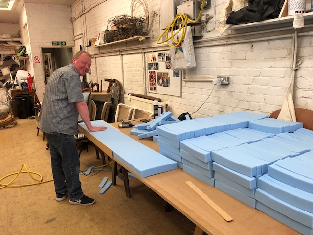 E & A Wates' upholsterer Tom cutting foam visor components while the workshop is closed during Covid-19.